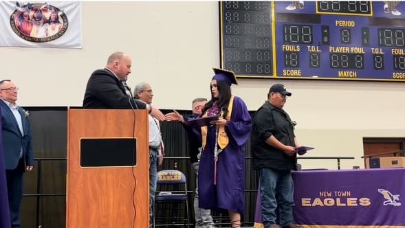 Alexandrea Brugh receives her high school diploma during New Town High School Graduation on May 26, 2024. (Photo Credit, James Brugh)