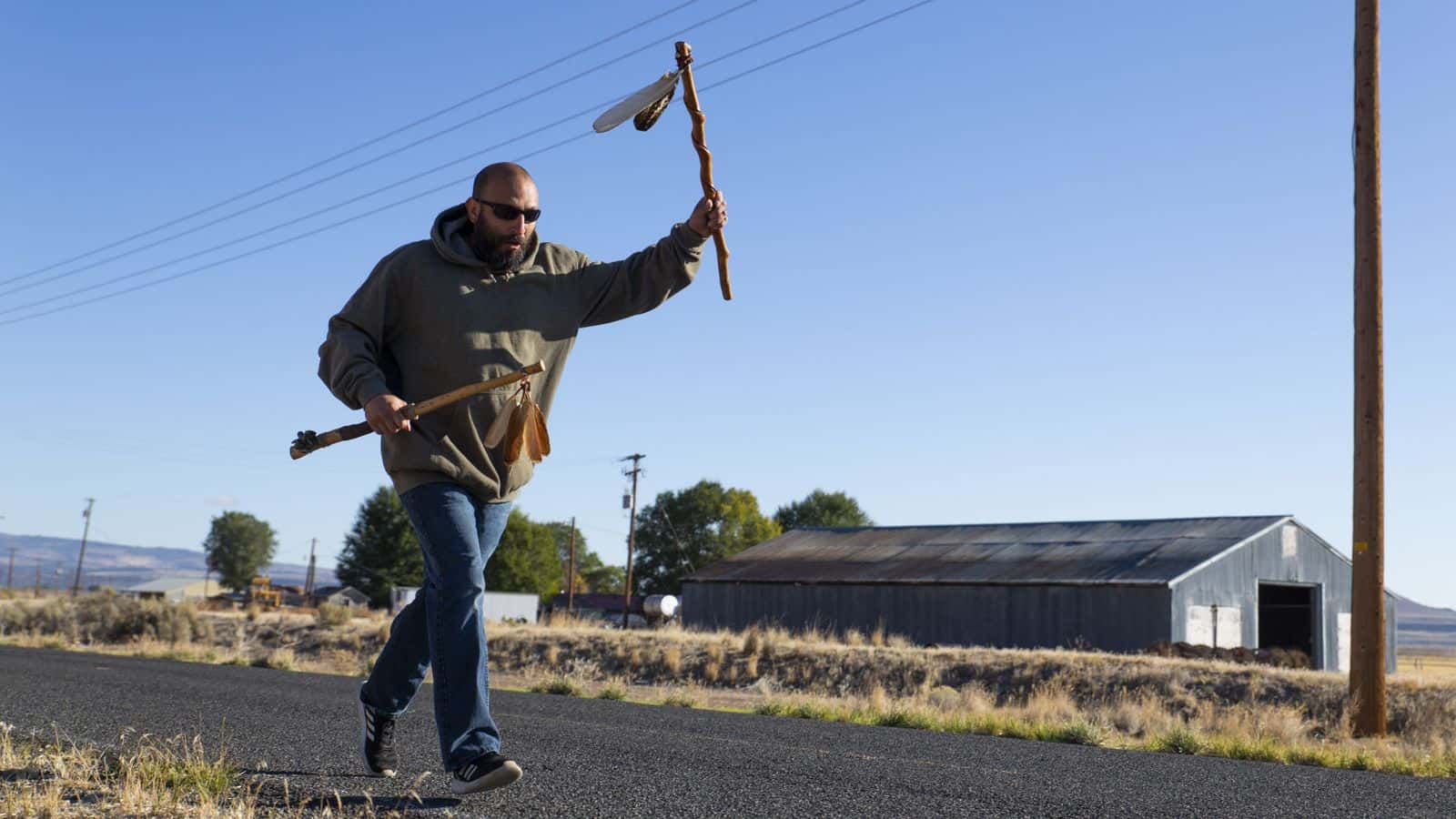 James Ramos runs with the staff held high during the annual Modoc Ancestral Run on Oct. 9