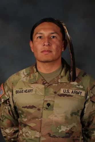 Spc. Moses Brave Heart of the South Dakota Army National Guard’s 235th Military Police Company is pictured with his eagle feather as he exercises his right to grow his hair out in accordance with his religious beliefs and culture as a member of the Oglala Sioux tribe and his exception to policy in accordance with regulations and in accordance with 1978 Indian Religious Freedom Act. U.S. Army National Guard photo by Staff Sgt. Breanne Donnell