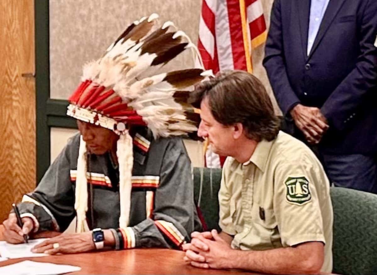 In Rapid City, South Dakota, on Aug. 22, Arvol Looking Horse signed the Great Sioux Nation and U.S. Forest Service MOU on Black Hills co-stewardship. Accompanying him was Black Hills National Forest Supervisor Shawn Cochran. (Photo credit/ Mark Van Norman)