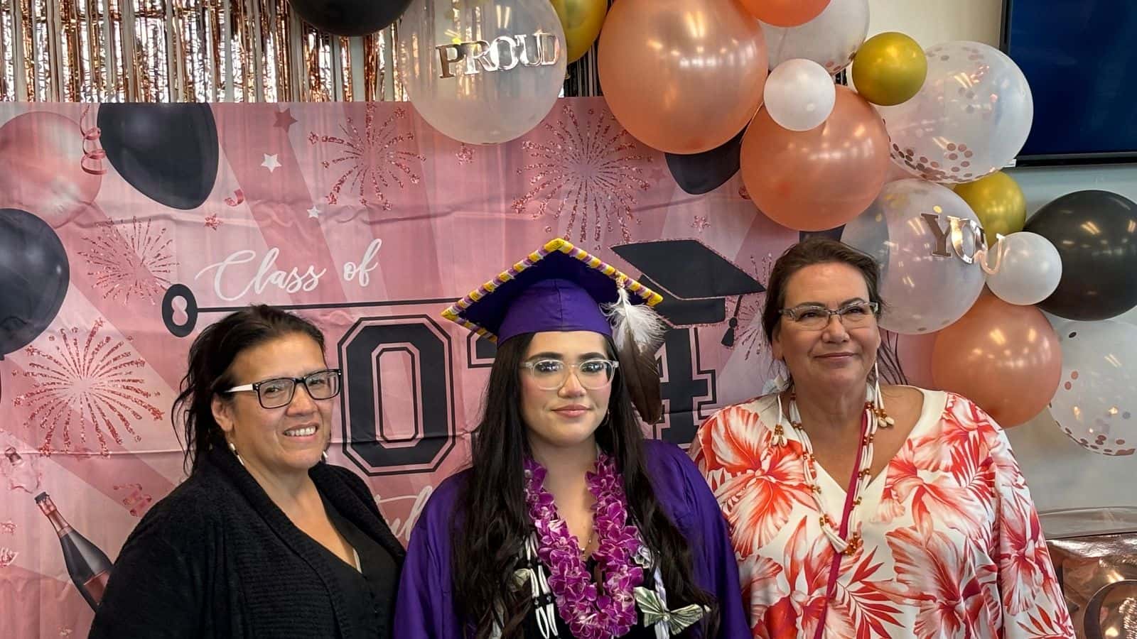 Blanca Windy Boy (right), Alexandrea Brugh (center) and Jodi Spotted Bear, celebrate Alexandrea’s May 26, 2024 graduation from New Town High School. (Photo Credit, James Brugh)