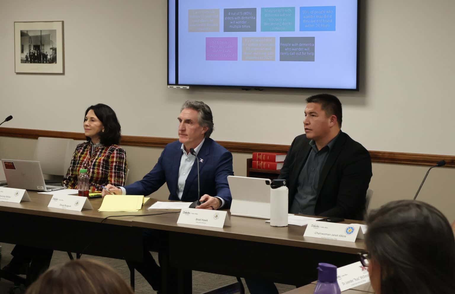 North Dakota Indian Affairs Commission Executive Director Brad Hawk, right, participates in a commission meeting Feb. 28, 2024, at the Capitol with Lt. Gov. Tammy Miller and Gov. Doug Burgum. (Mary Steurer/North Dakota Monitor)