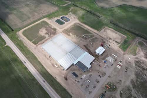 This aerial photo shows the first phase of the Mandan, Hidatsa and Arikara Nation's Native Green Grow greenhouse operation on May 15, 2024, near Parshall, N.D. The greenhouse is planned for growing large quantities of leafy greens and vine crops for exports, distribution on the Fort Berthold Indian Reservation, to other tribes in neighboring states and food banks for isolated and impoverished areas. (RML Architects via AP)