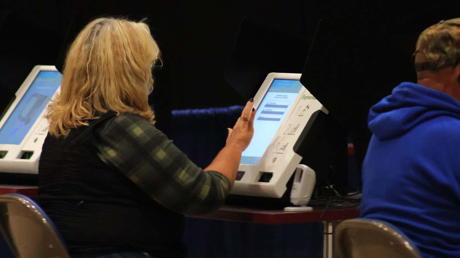 A voter fills out a ballot using a touch screen device during the first day of early voting in Burleigh County at the Bismarck Event Center on Oct. 24, 2024. (Michael Achterling/North Dakota Monitor)