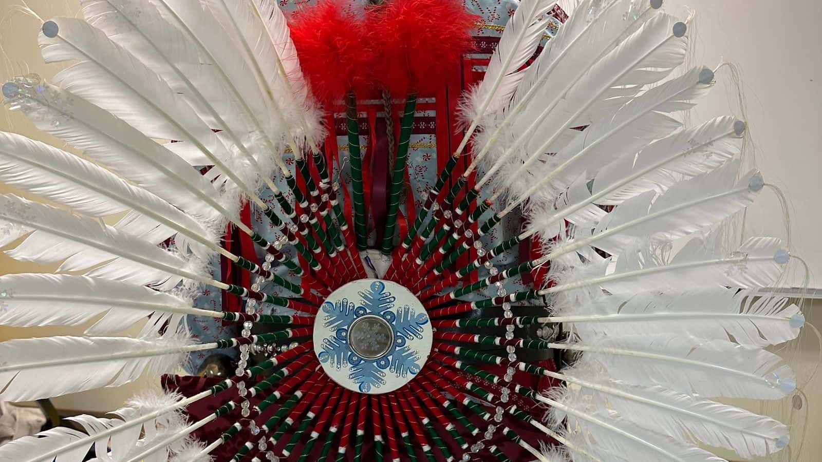 A large feather bustle adorned with a beaded snowflake and mirror make up part of Solte Santa’s regalia. (Buffalo’s Fire/Brian Bull)