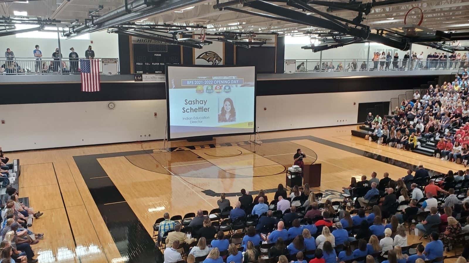 Sashay Schettler, Bismarck Public Schools Indigenous education director, delivers a land acknowledgement in 2021-22 to fellow school district staff members at Legacy High School in Bismarck, N.D. Schettler is a citizen of the Mandan, Hidatsa and Arikara Nation. Photo Credit/Bismarck Public Schools