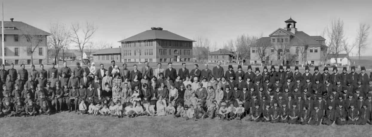 Kibbe Brown's aunt who attended the Rapid City Indian School had saved a panoramic photo of students and staff from between 1925-27, with the school's campus in the background. (Photo courtesy of Remembering the Children)