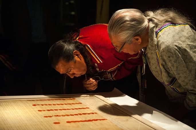 Haudenosaunee Tadadaho (head chief) of all the Six Nations, Sid Hill, and Faithkeeper Oren Lyons, examine the encased Treaty of Canandaigua on the day it was installed in the Nation to Nation exhibition, September 2014. Their ancestors witnessed and signed the Treaty, and their DNA is on it. (Photo: National Museum of the American Indian)