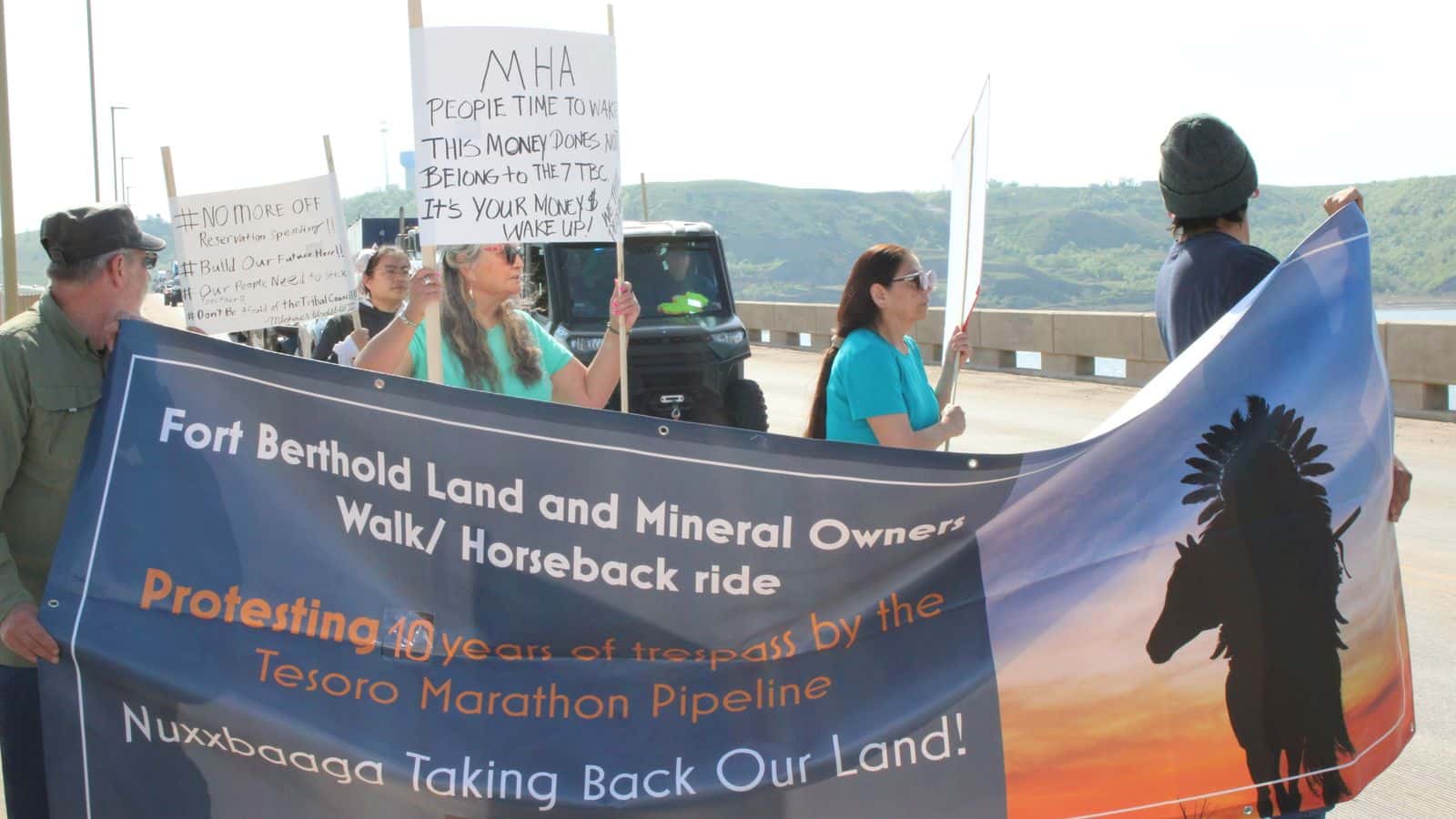 Protesters who object to Mandan, Hidatsa and Arikara Nation Tribal Business Council's lack of accountability to the people, carried a sign noting the Tesoro High Plains Pipeline trespass on individual owners allotted land near Mandaree, N.D. Photo by Jodi Rave Spotted Bear
