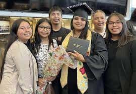 Sherraine White, far left, Mille Lacs Band of Ojibwe, is now the matriarch of her family at age 23 after the loss of her mother, grandmother and other family members in the last few years. She is shown here at the graduation of her sister, Valerie Mitchell, with siblings, from left, Aniyah White, Matthew Mitchell, Waylon Mitchell, and Jayenissa Mitchell. (Photo courtesy of Sherraine White)