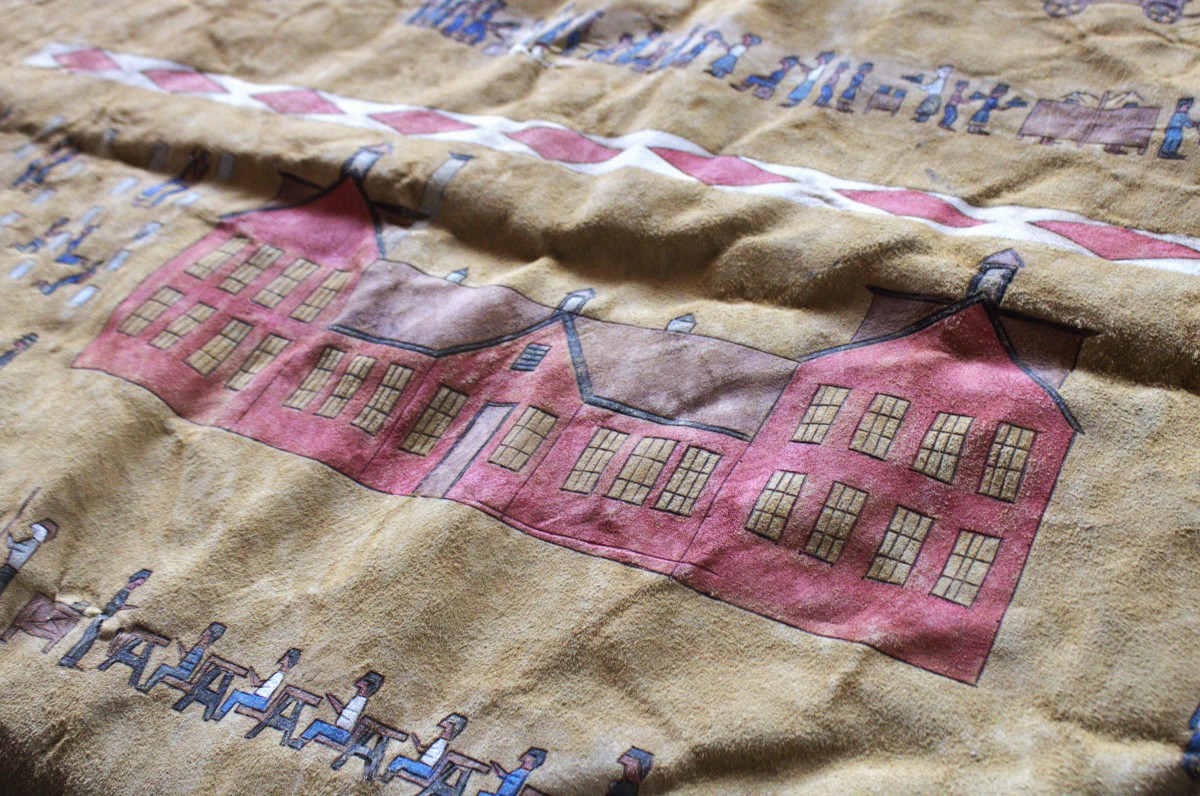 A winter count on a buffalo hide stored in the Remembering the Children Exhibit depicts a year at the Rapid City Boarding School. Winter counts are a traditional way for plains tribes to depict and remember significant events from the year, this winter count depicts a year spent away. (Photo by Amelia Schafer, ICT/Rapid City Journal)