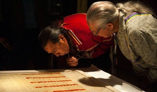 Haudenosaunee Tadadaho (head chief) of all the Six Nations, Sid Hill, and Faithkeeper Oren Lyons, examine the encased Treaty of Canandaigua on the day it was installed in the Nation to Nation exhibition, September 2014. Their ancestors witnessed and signed the Treaty, and their DNA is on it. (Photo: National Museum of the American Indian)