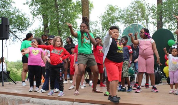 Geraldine Ambe, one of the organizers, led children in a dance onstage at Bismarck’s second Juneteenth celebration on June 19. 
(Photo credit/Alicia Hegland-Thorpe)