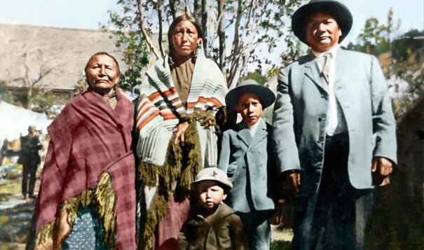 Stephan Curran colorized this 1930s photo showing the family of HAWK 1890 member Marlis Afraid of Hawk at Pine Ridge Reservation. Left  to right, her great-grandmother "He Ska Win"/White Mountain Woman; grandmother Mabel Cetan Kokipa/Afraid of Hawk; grandfather Richard Cetan Kokipa/Afraid of Hawk; and their two sons, Bert and Cain Cetan Kokipa/ Afraid of Hawk. Grandfather Richard survived the massacre. (Family photo courtesy of Marlis Afraid of Hawk)