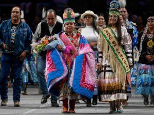 Wanbli Waunsila Wi Eagle walks with Taylor Campbell, the 2022-2023 Miss He Sapa Win, after her crowning during the 2023 He Sapa Wacipi in Rapid City. (Photo by Matt Gade, Rapid City Journal)