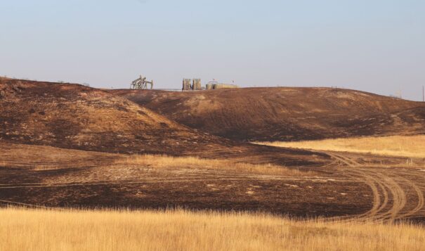 Oil wells continue to operate near scorched ground south of Watford City on Oct. 9, 2024. (Jacob Orledge/North Dakota Monitor)
