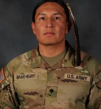 Spc. Moses Brave Heart of the South Dakota Army National Guard’s 235th Military Police Company is pictured with his eagle feather as he exercises his right to grow his hair out in accordance with his religious beliefs and culture as a member of the Oglala Sioux tribe and his exception to policy in accordance with regulations and in accordance with 1978 Indian Religious Freedom Act. U.S. Army National Guard photo by Staff Sgt. Breanne Donnell