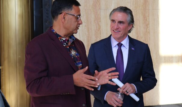 Mandan, Hidatsa and Arikara Nation Chair Mark Fox, left, speaks with North Dakota Gov. Doug Burgum in Memorial Hall during a signing event for an alcohol tax revenue sharing agreement between the state and the MHA Nation on March 22, 2024. (Michael Achterling/North Dakota Monitor)