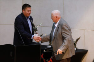  Thomas Fredericks, a retired tribal law attorney, receives a leadership award from Indian Affairs Commission Executive Director Brad Hawk during the North Dakota Native American Hall of Honor induction ceremony on Nov. 15, 2024. Fredericks is a member of the Mandan, Hidatsa and Arikara Nation. (Kyle Martin/For the North Dakota Monitor)